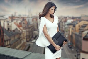 Woman in white dress standing on roof