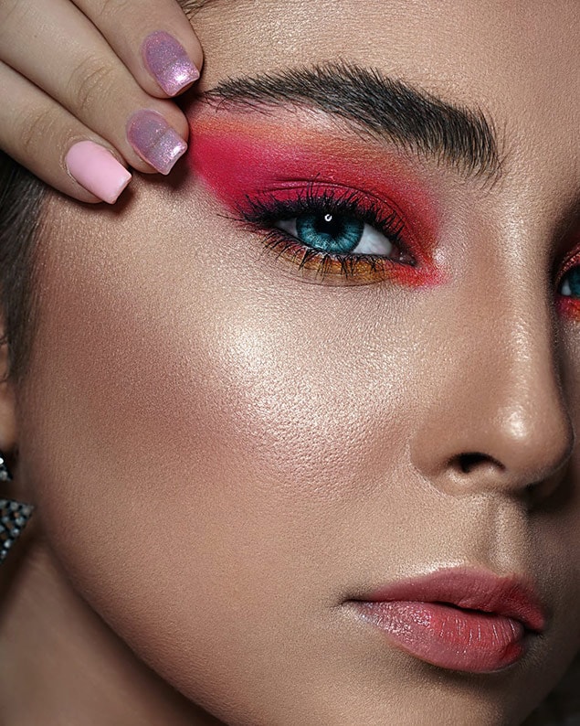Womans face with red pink makeup Womans face with red pink makeup