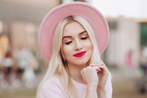 Woman with pink hat smiling